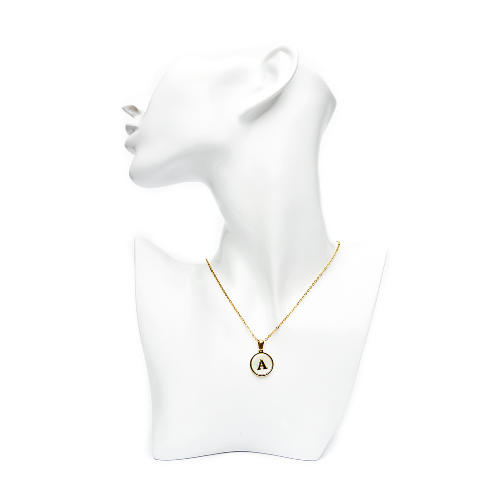Gold initial 'A' letter necklace on a white mannequin bust, showcasing a sophisticated and personalized style