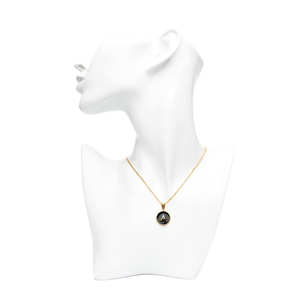 Gold initial 'A' letter necklace on a white mannequin bust, offering a personalized touch with a stylish black and gold contrast.
